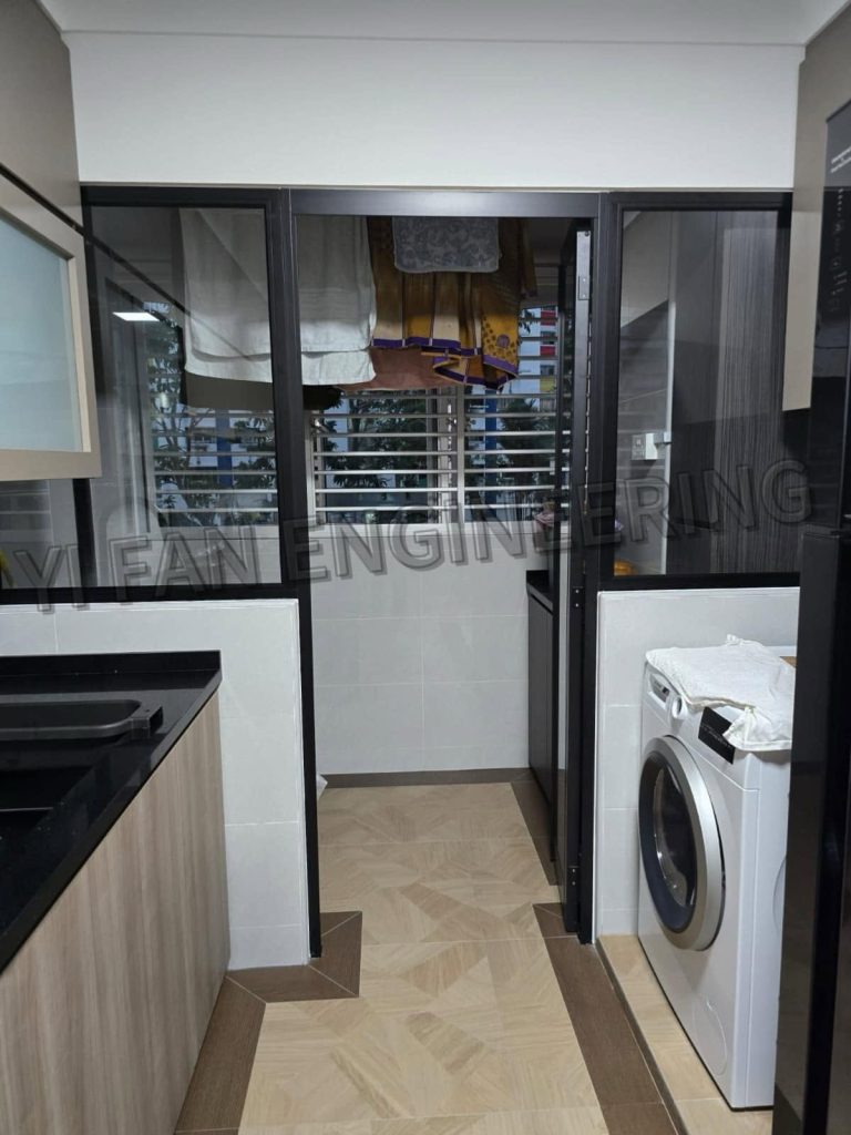 Portfolio image of a completed service yard project, highlighting custom dark Service Yard Window Grilles by Yi Fan Engineering installed above a uniquely tiled floor and washing machine area.