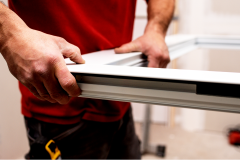 Technician installing an aluminium window frame, showcasing one of our client’s window installation services in Singapore.